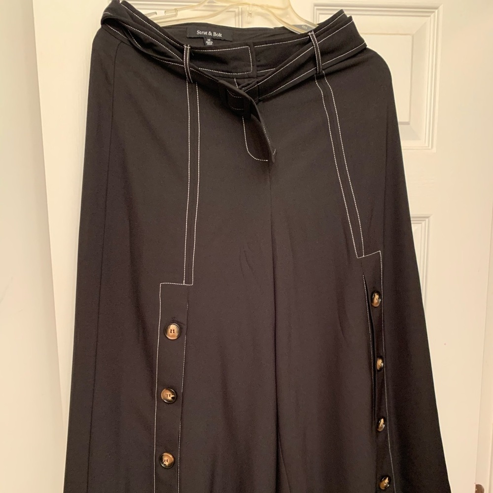 Dress pants with buckle on hips.